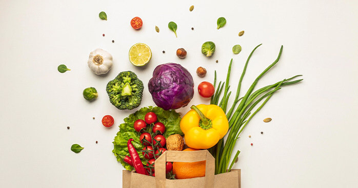 Paper bag full of fruits and vegetables.